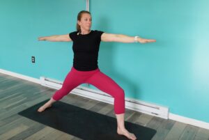 Dr. Chloe with 1 foot in front of her, kinee bent, the other leg behind facing perpendicularly to the front foot. Keep your arms open and in line with the front leg to stretch the adductors and improve running form